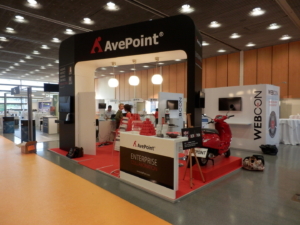 Custom exhibition stand designed and produced by ProjeKta for AvePoint, featuring sleek branding and innovative structure for international trade shows.