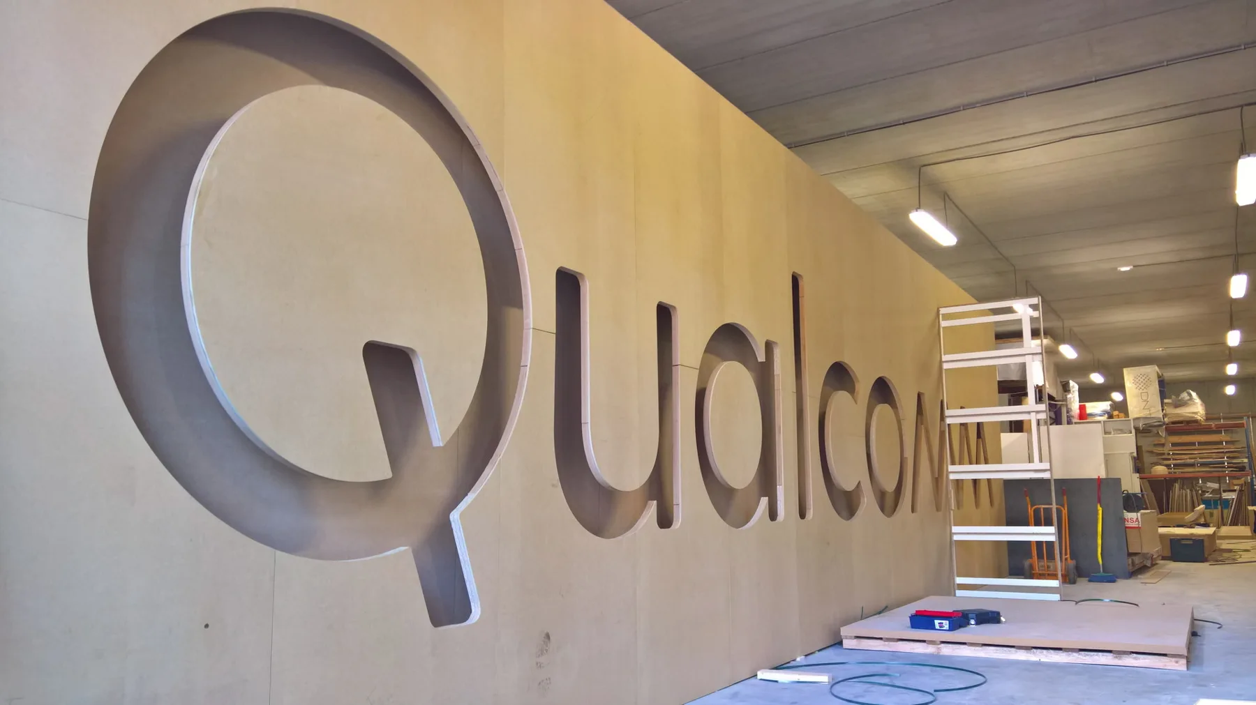 Letras corpóreas de Qualcomm durante la preparación de los elementos del stand.